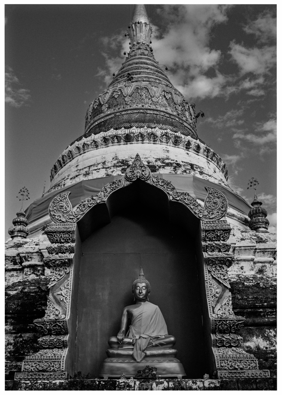 Pagode mit Buddha-Statue und Ornamenten vor bewölktem Himmel, © Klaus Gruber | Fotograf Fürth